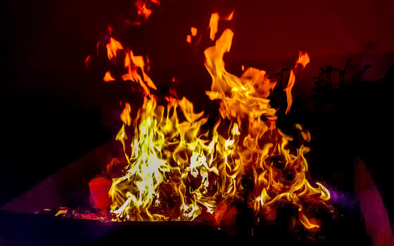 Fire and flames on barbecue in the dark Maldives. photo