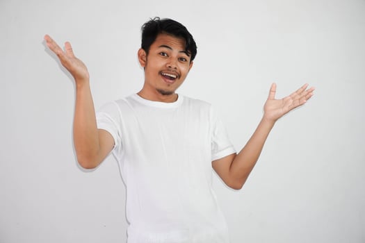 shock asian man with open hands and mouth wearing white t shirt isolated on white background photo