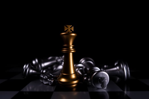 Golden King chess is last standing in the chess board, Concept of successful business leadership photo