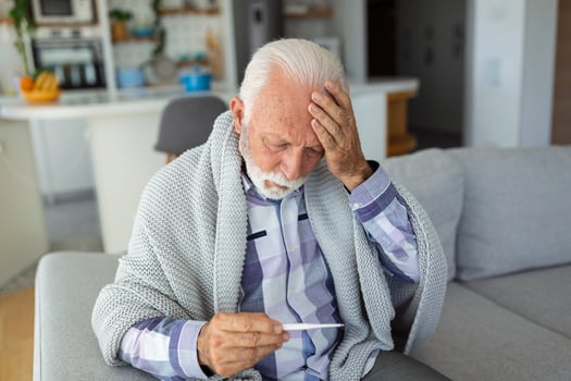New coronavirus CoVid-19 outbreak situation with pandemic epidemic warning - adult caucasian senior old man with fever symptoms like illness cold seasonal influenza - people and virus concept photo