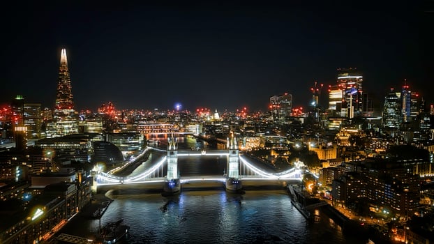 Scenic aerial view of the Tower Bridge and city at night in London photo