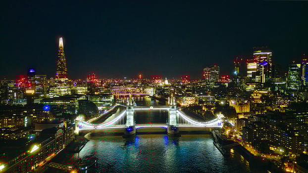 Scenic aerial view of the Tower Bridge and city at night in London photo