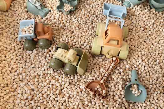 A modern children's sandbox with toys. Sandbox filler in the form of wooden small wooden cubes photo