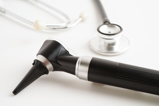 Otoscope isolated on white background for otolaryngologist or ENT physician doctor examining senior patient ear, hearing loss problem. photo