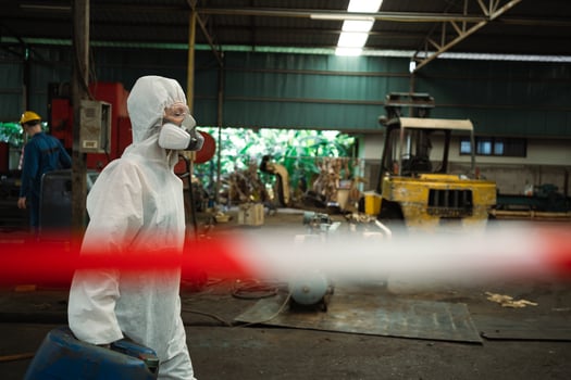 Workers wearing safety suits and gas masks under inspection of chemical tanks in industrial work with hazardous chemicals. photo