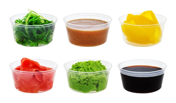 Soy sauce, wasabi, pickled ginger, chuka, sesame sauce and pickled radish isolated on white background photo