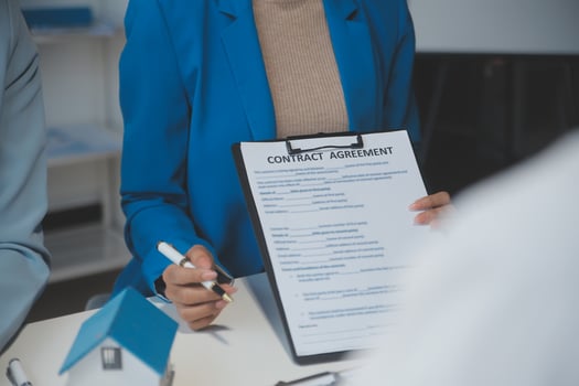Real estate agent and customer signing contract to buy house, insurance or loan real estate.rent a house,get insurance or loan real estate or property. photo