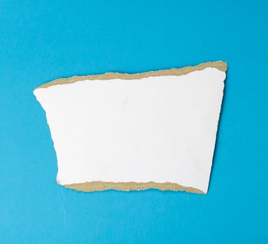 A white piece of paper teared isolated on white background photo