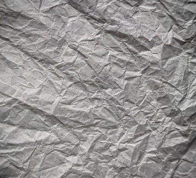 The texture of the crumpled gray paper. Abstract background. Selective focus. photo