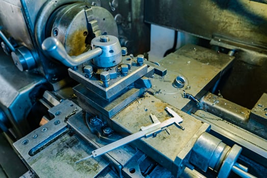 metal lathe processes metal parts on the production in the plant. The work process of the lathe. Close-up photo