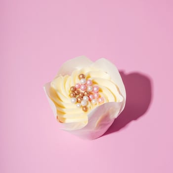 Sweet dessert cupcakes with cream and with pearl decor on pink background photo