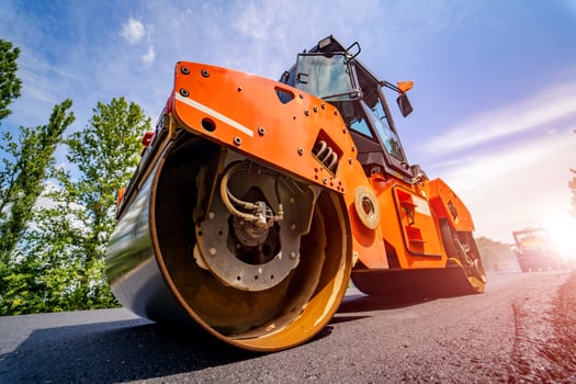 Road repair, compactor lays asphalt. Heavy special machines. Asphalt paver in operation. Side view. Closeup. photo