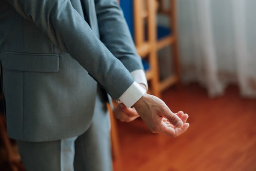 The man put on his shirt and straightens cufflinks. The groom fasten cufflinks on the cuffs of the shirt. The businessman fasten cufflinks on the cuffs of the shirt. Concept successful businessman. photo