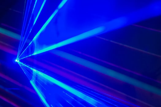 Laser beam on blue background photo