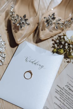 Stylish wedding rings. Letters from the bride and groom. Promises Engagement. Luxury marriage and wedding accessory concept. two wedding rings and a wedding invitation photo