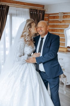 A beautiful bride with her father on her wedding day. The best moments of the wedding day. Daughter and father. photo