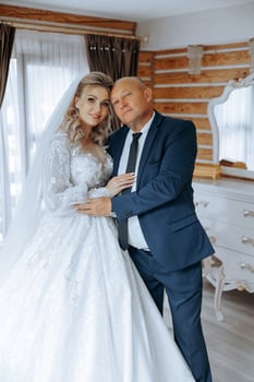 A beautiful bride with her father on her wedding day. The best moments of the wedding day. Daughter and father. photo