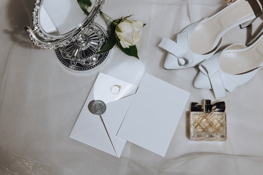 Bride's wedding ring on high-heeled shoes, women's perfume, wedding glasses. Wedding details. High quality photo