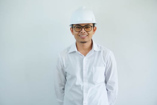 smiling young Asian man engineering showing excited expression with looking camera isolated on white background photo