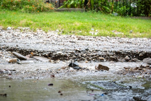 Dirt street in a neighborhood broken by the fall of rain. photo