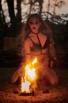 Girl fire dancing performance at outdoor art festival, smooth movements of female artist photo