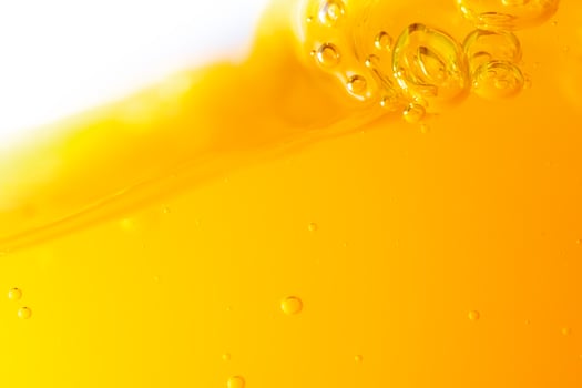 Close up bright orange juice splash texture for health and nature waves, Beautiful waves curve and little bubbles smooth for garphic design and background photo