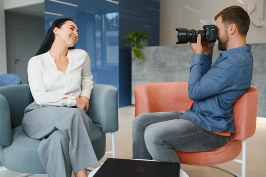 Male photographer taking picture of young woman photo