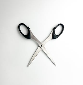 Stainless steel opened scissors with black colored handle. Cutting object photography isolated on plain studio background. photo