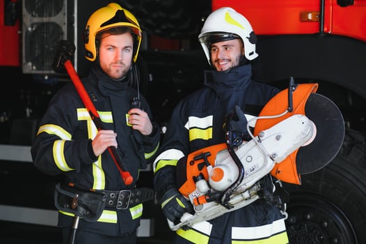 Portrait of two heroic fireman in protective suit and helmet. photo