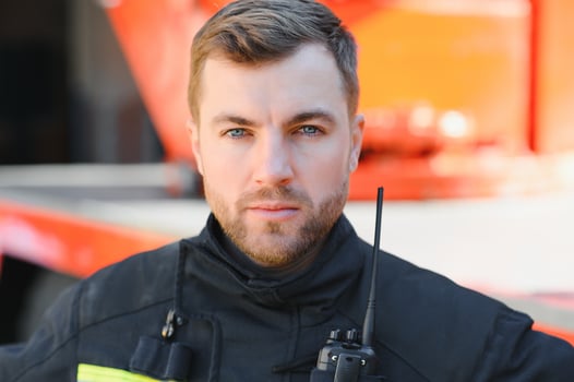 Fireman firefighter in action standing near a firetruck. Emergency safety. Protection, rescue from danger. photo