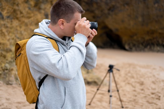 Traveler photographer takes photo beautiful seascape