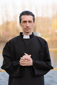 Portrait of handsome catholic priest or pastor with collar photo