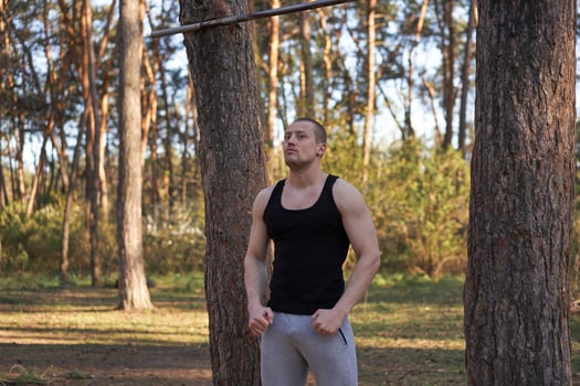 Handsome caucasian men pull-up outdoor workout cross training morning Pumping up arm exercising sports ground nature forest photo