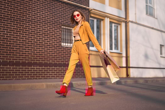 One Young Caucasian European girl Shopaholic walking along the street with purchases in packages. photo