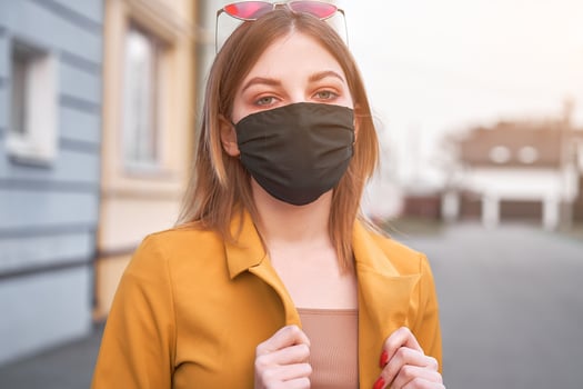 Young Caucasian European girl 20 years old wearing black protective medical mask protection against epidemic coronavirus covid-19 photo