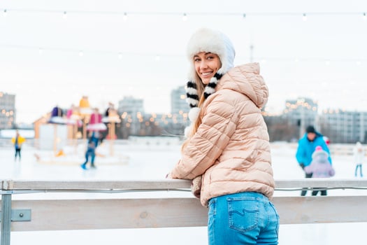 Winter woman portrait. Beautiful middle age caucasian female standing outdoor dressed funny fluffy hat looking camera smile photo