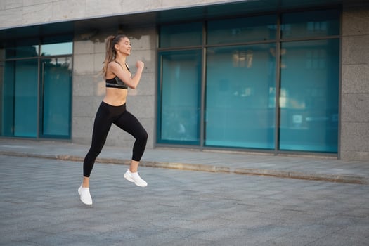 Woman running urban city street background photo