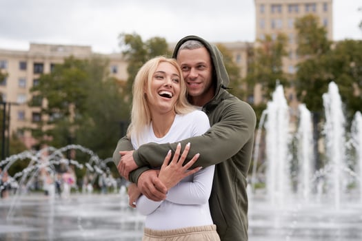 Couple in love walking outdoors park fountain Caucasian man woman walk outside after jogging dressed sport clothes photo