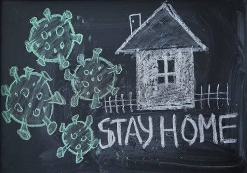 Hashtag stay at home. Outbreak Warning. written white chalk on blackboard in connection with epidemic of coronavirus worldwide. photo