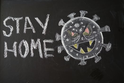 inscription stay at home. Outbreak Warning. written white chalk on blackboard in connection with epidemic of coronavirus worldwide. photo
