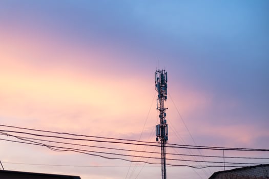 Cell Tower Silhouette Against Orange Sunset Communication Tower Technology Concept photo