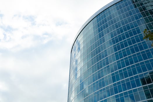 Detail blue glass building background with cloud sky photo