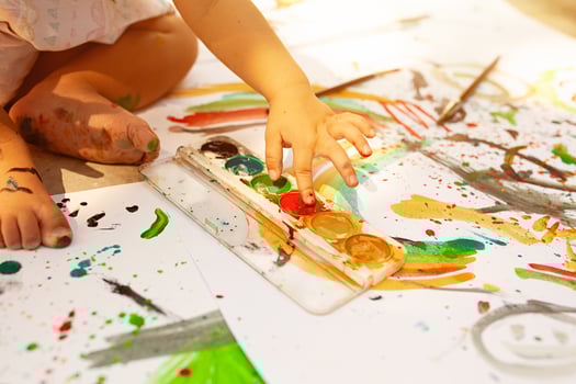 Portrait of little blonde girl painting, summer outdoor. photo
