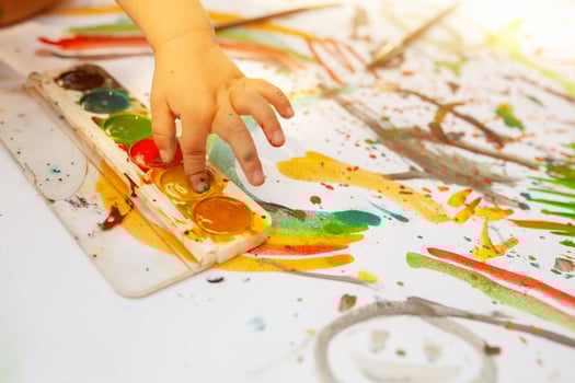 Portrait of little blonde girl painting, summer outdoor. photo