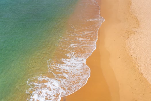 Aerial view of sea waves and sandy beach photo