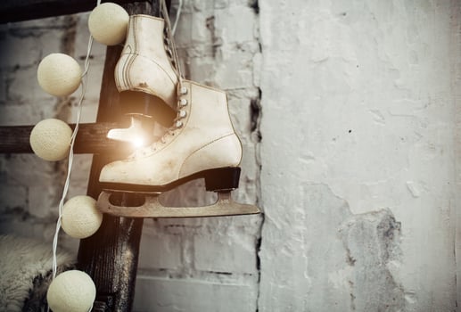 White skates at the wooden staircase. New year interior photo