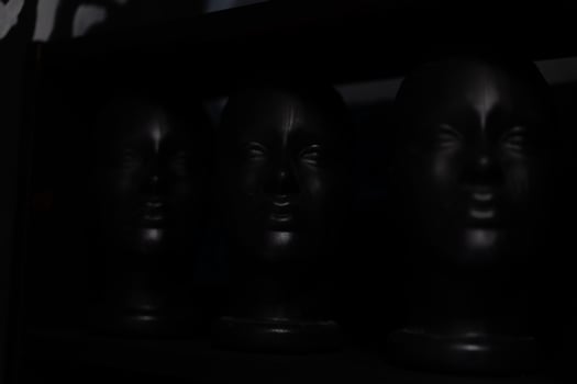 Black mannequin head on black background modern fashion abstract background photo