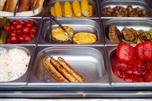 Street food grilled tomato, sausages, pineapple, sauerkraut, pepper, vegetable, corn, showcase market photo