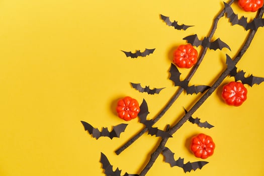 Halloween background, orange decorative plastic pumpkin black paper bat yellow cardboard Thanksgiving greeting card photo