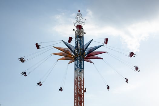 carousel in an amusement park with the people against the sky photo